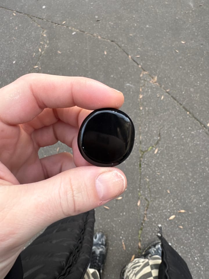 Solid, round chip of Black Obsidian.